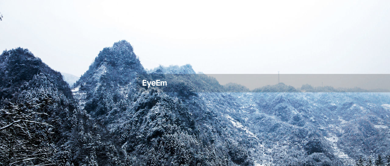 Scenic view of mountains against clear sky during winter