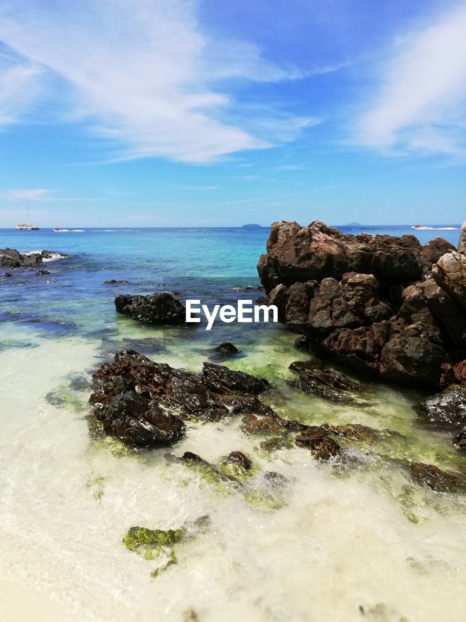 Rocks on beach against sky