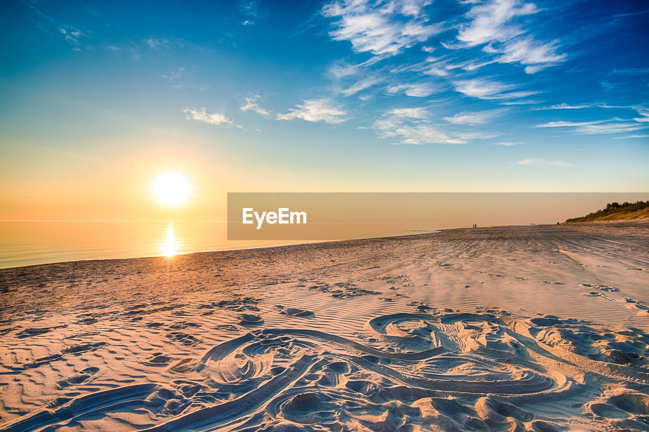 Scenic view of beach against sky during sunset