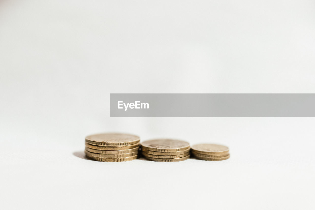 Close-up of coins on white background