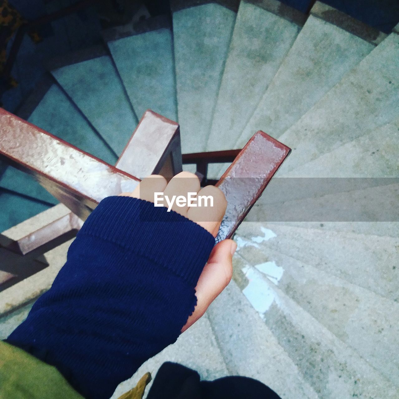 Cropped image of woman holding railing