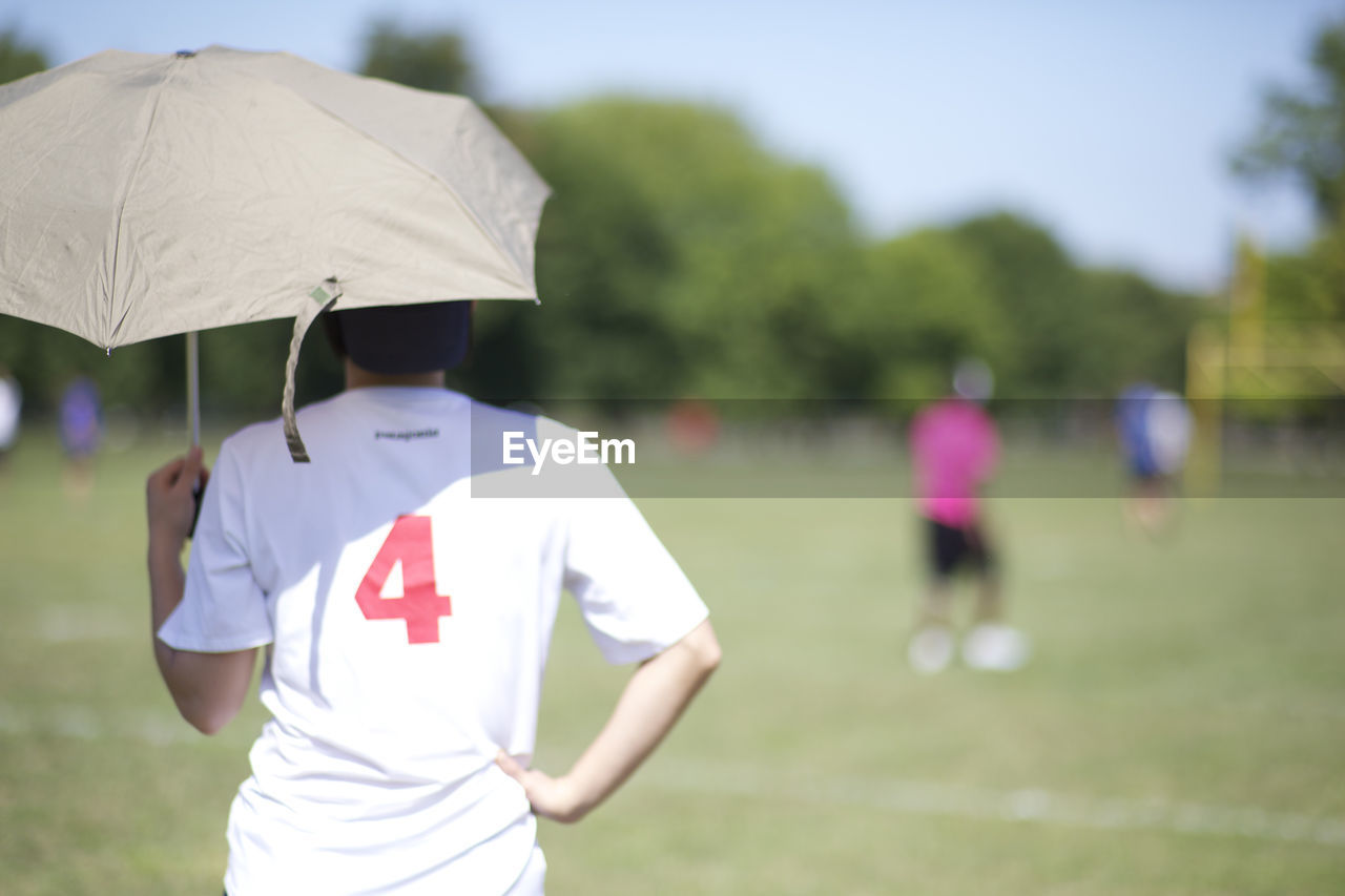 Rear view of man standing on playground