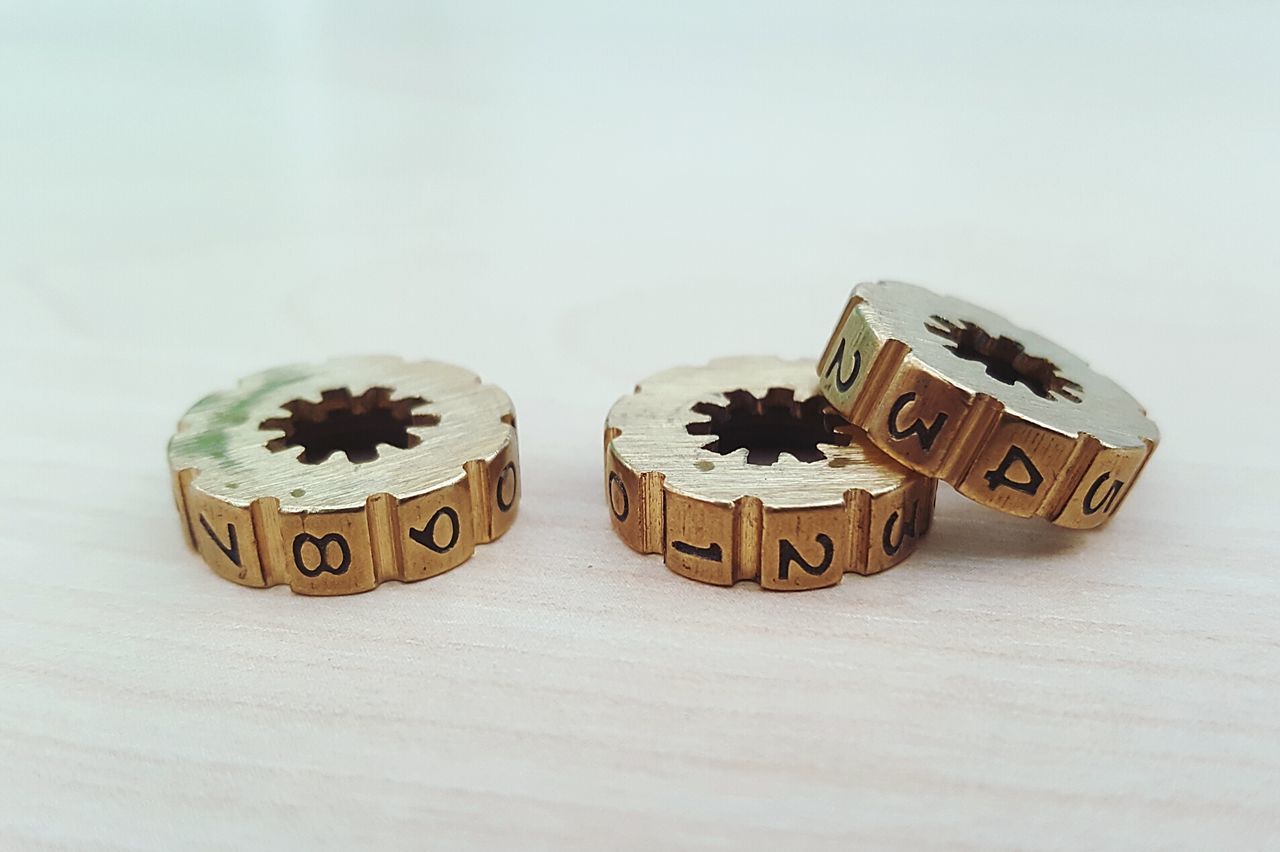 Close-up of metallic gears with numbers on table