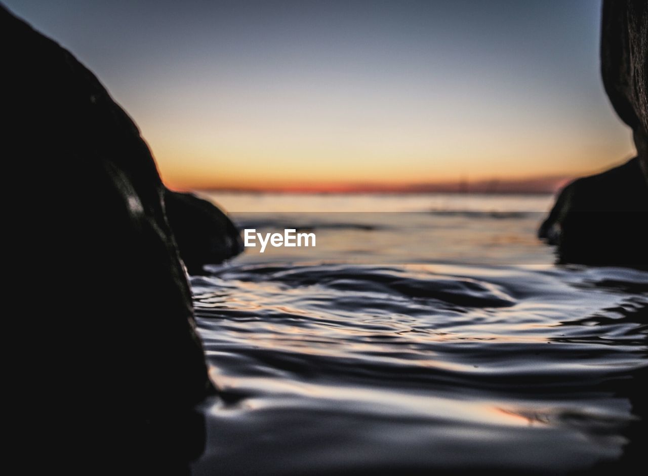 Scenic view of calm sea at sunset