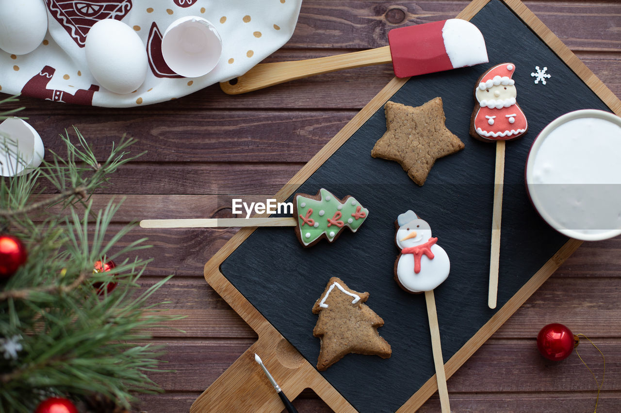 Flat lay with traditional christmas gingerbread. process of homemade decoration. new year holidays