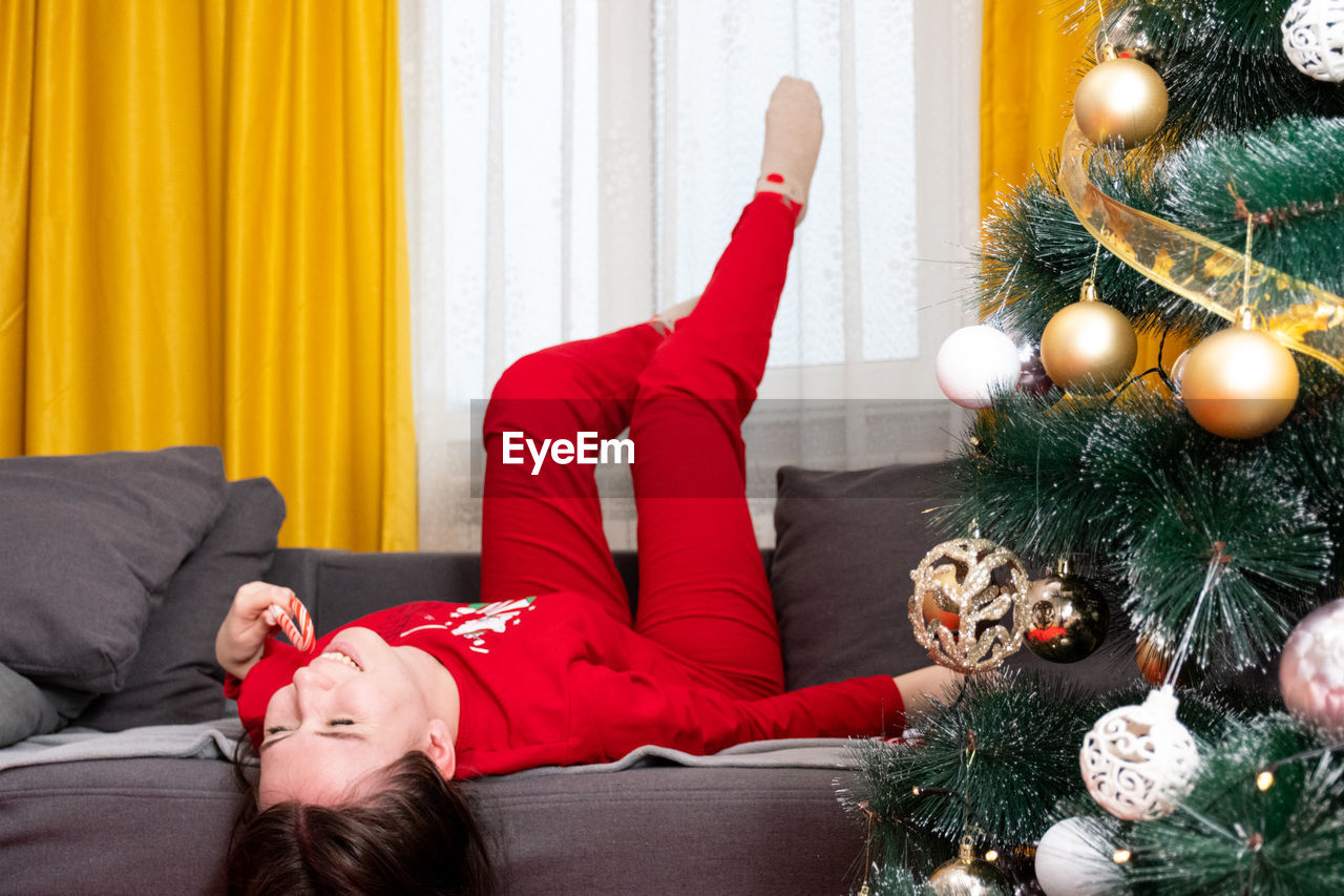 Portrait of young woman sleeping on bed at home