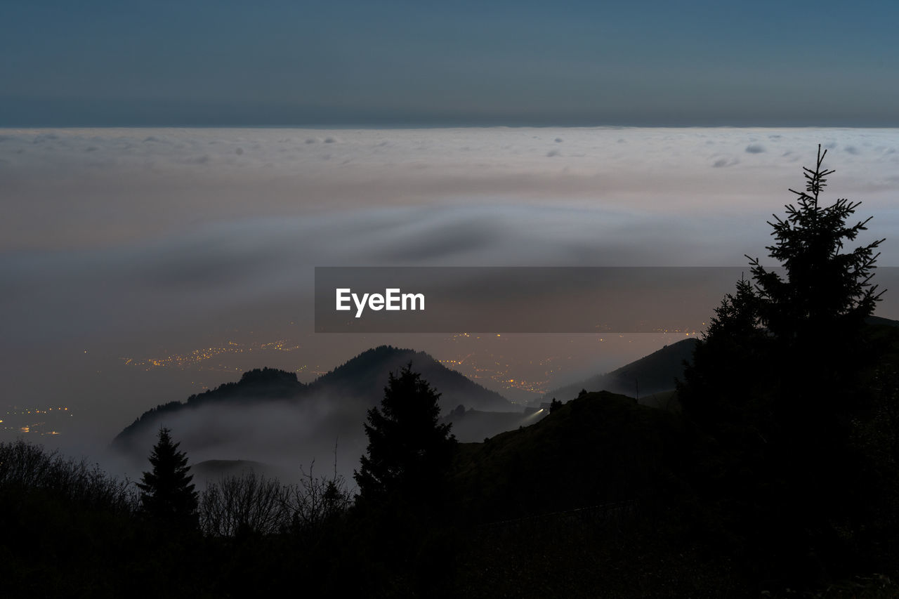 Scenic view of silhouette mountains against sky during sunset