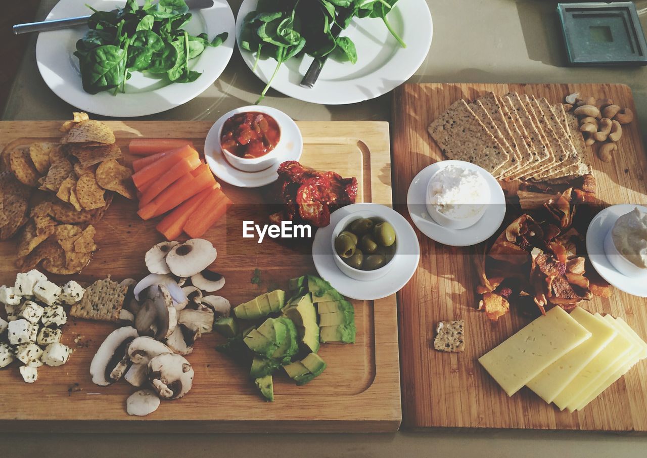 High angle view of various foods on cutting boards in kitchen