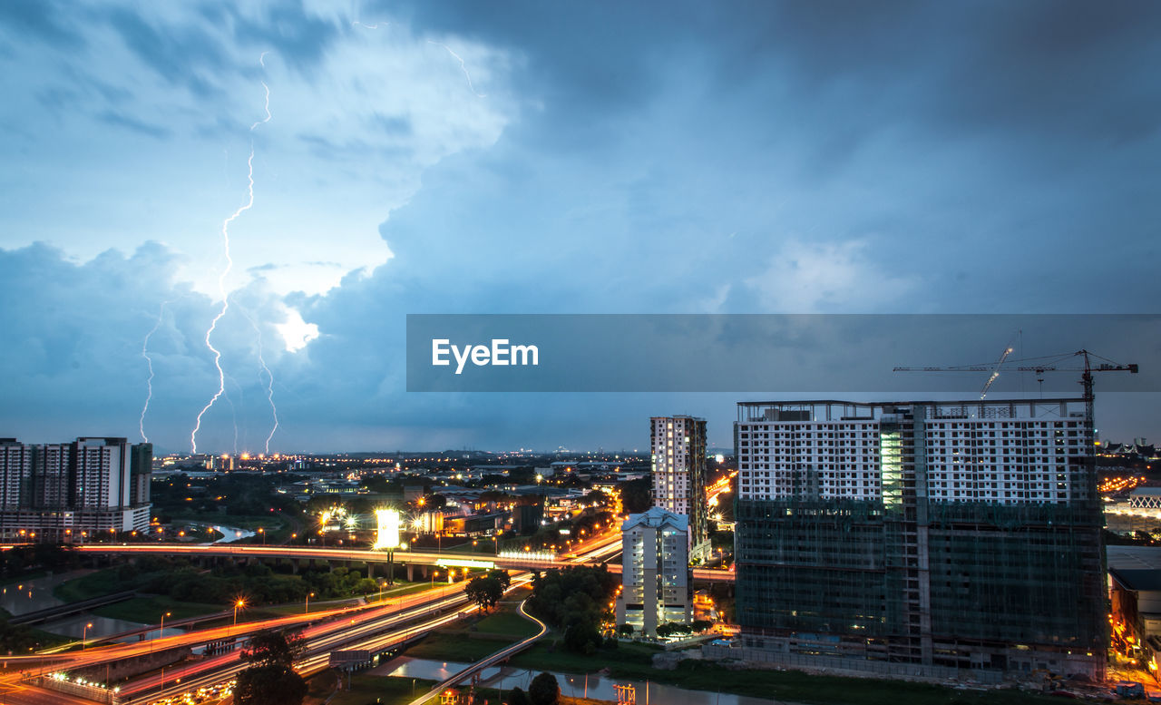 Panoramic view of illuminated city against sky at night