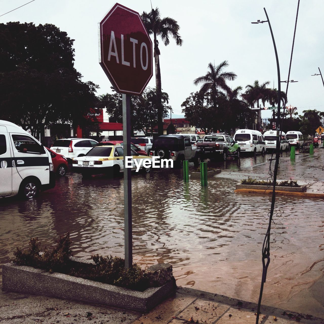 Traffic on flooded street against clear sky