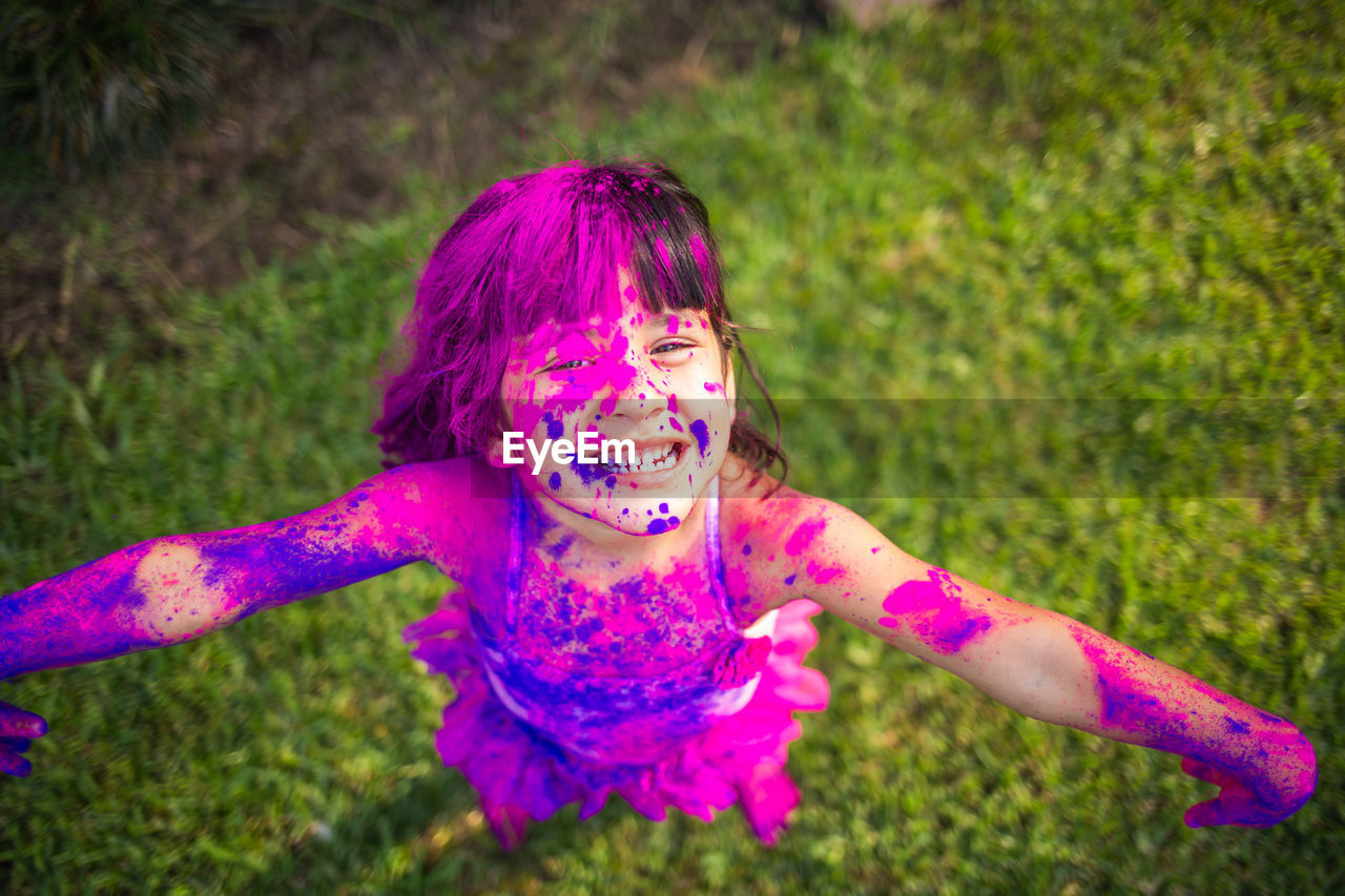 Portrait of happy girl enjoying holi