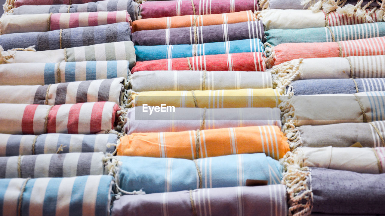 Full frame shot of rolled up fabrics at store