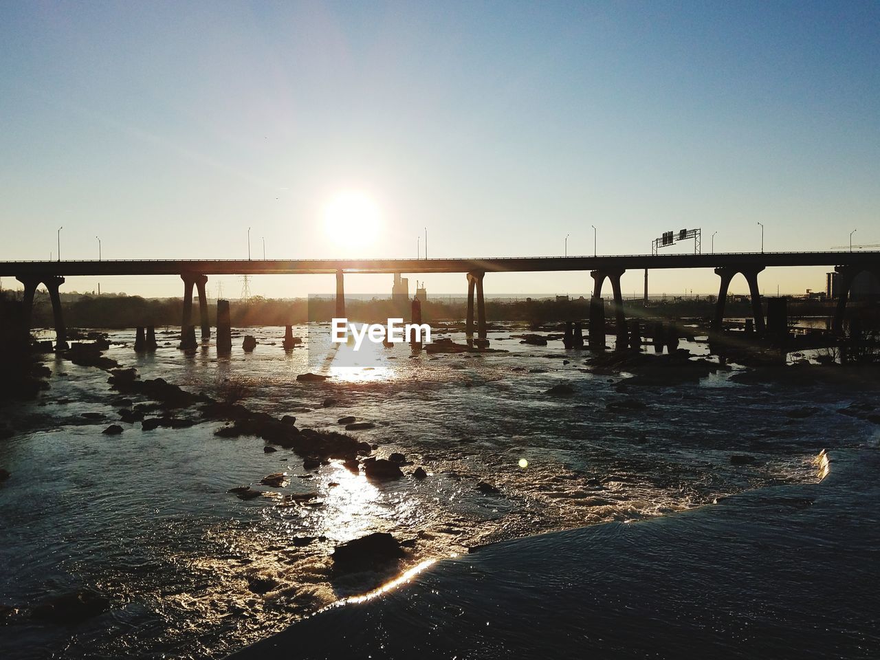 View of bridge over river against clear sky