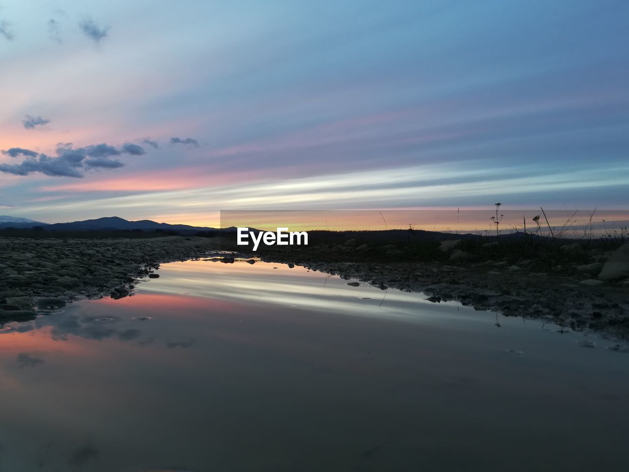 Scenic view of beach against sky during sunset