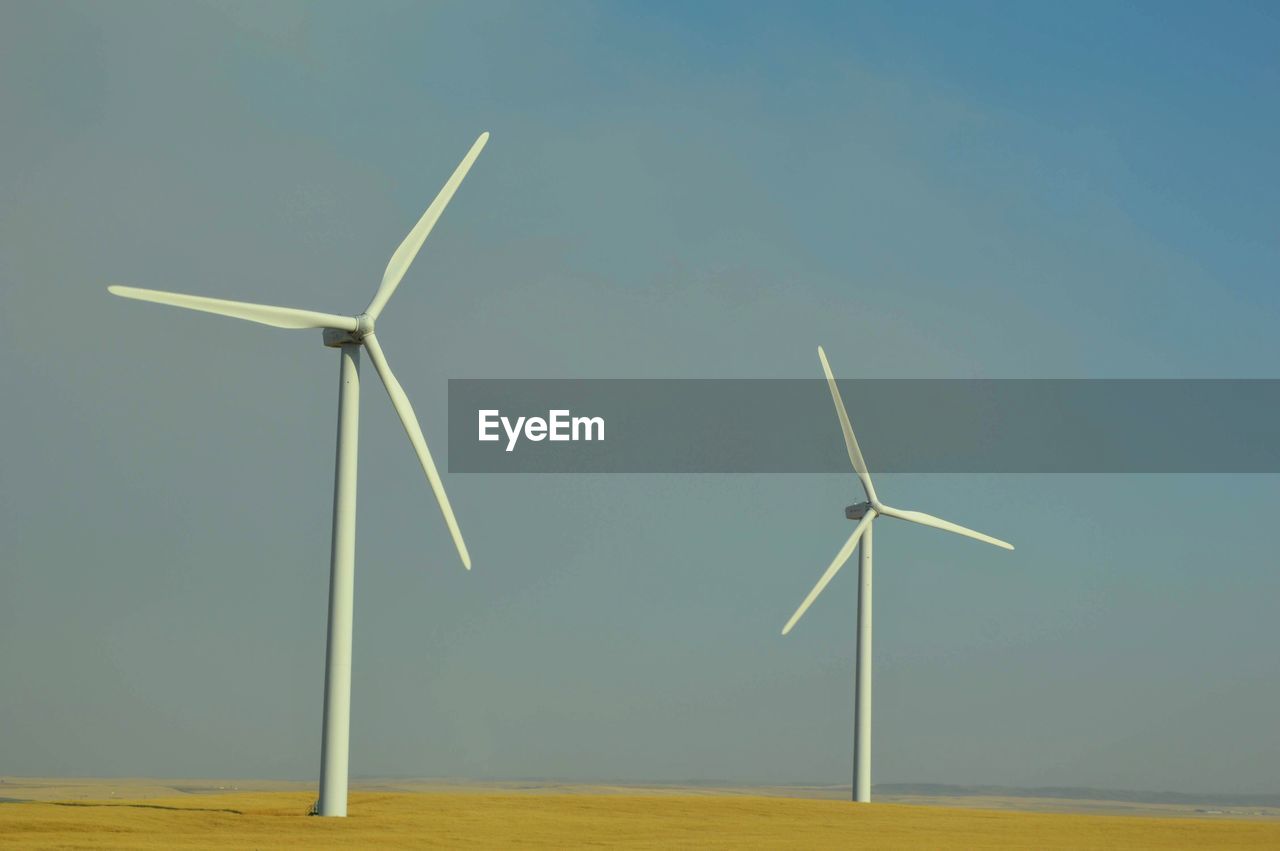 windmill on field against sky