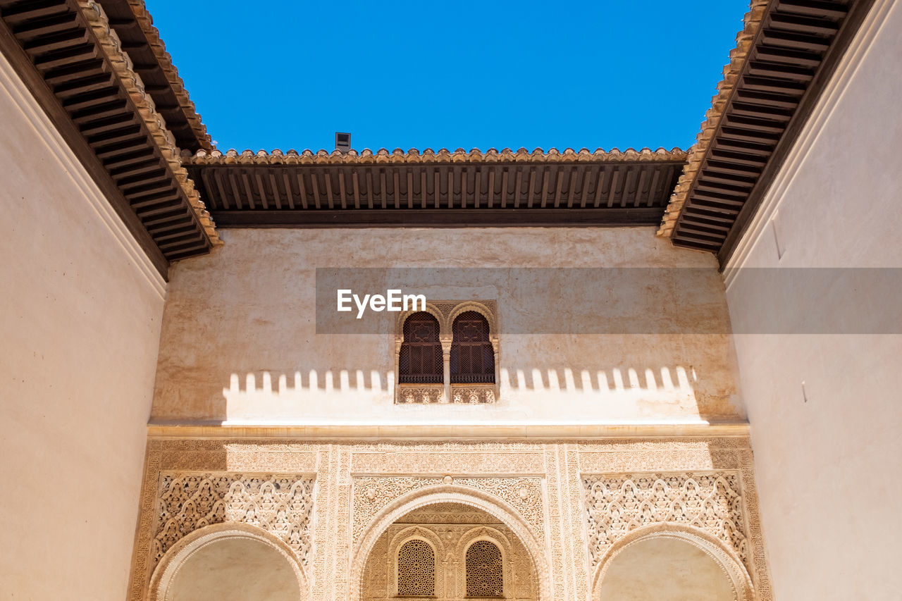 Low angle view of a building against blue sky