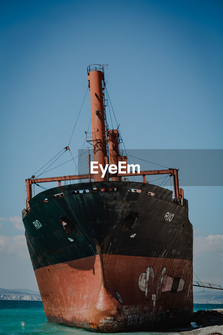 Ship on sea against clear blue sky