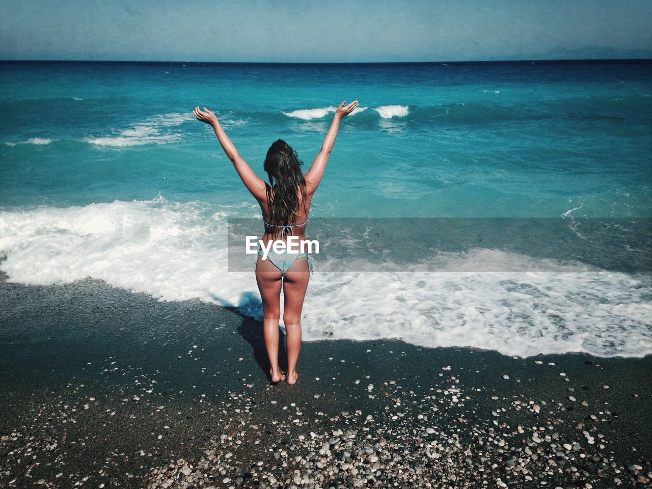 Young woman standing on beach