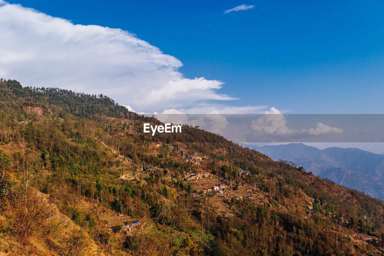 Scenic view of mountains against blue sky