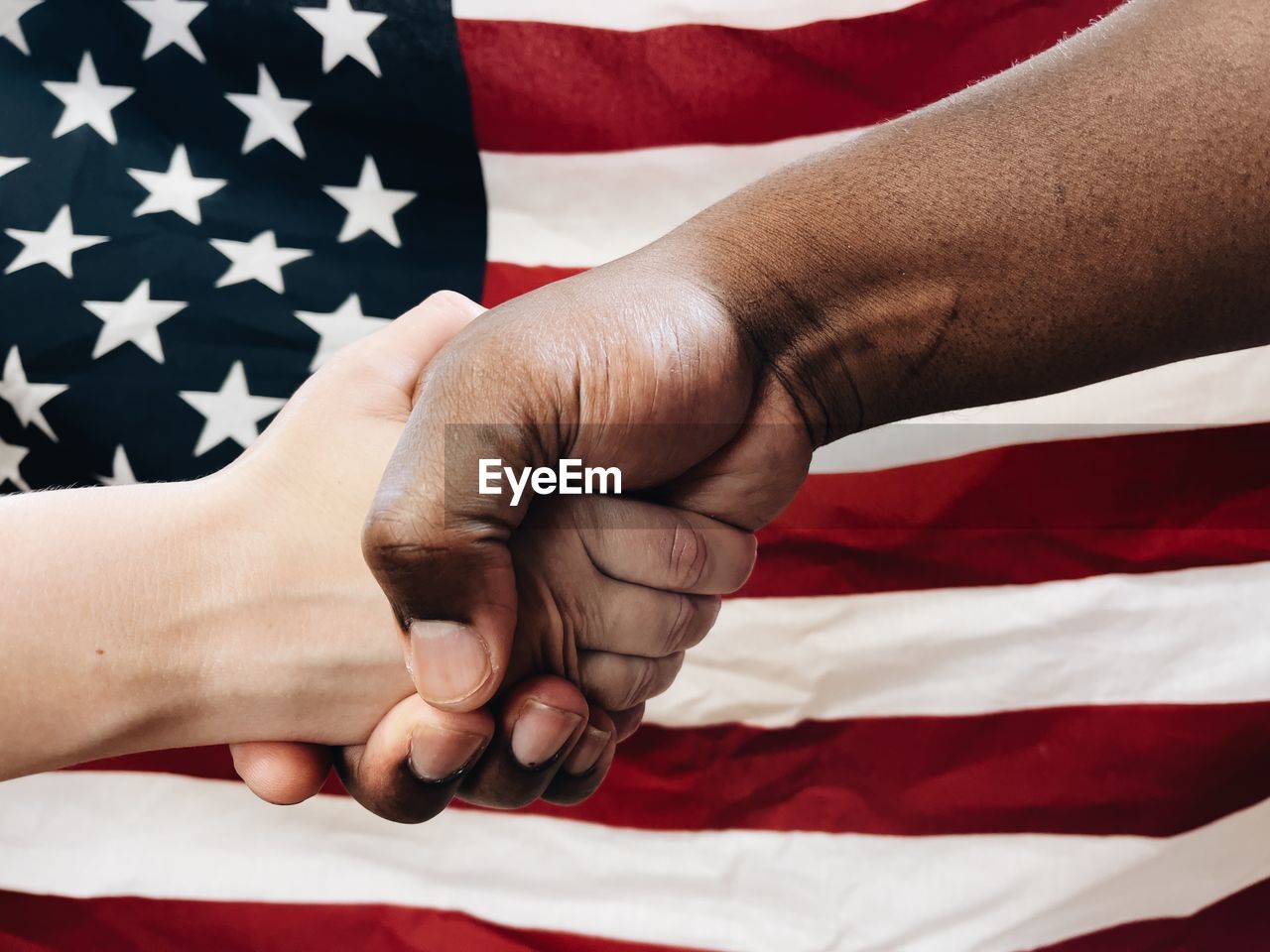 African american man and caucasian woman holding hands or shaking hands togetherness