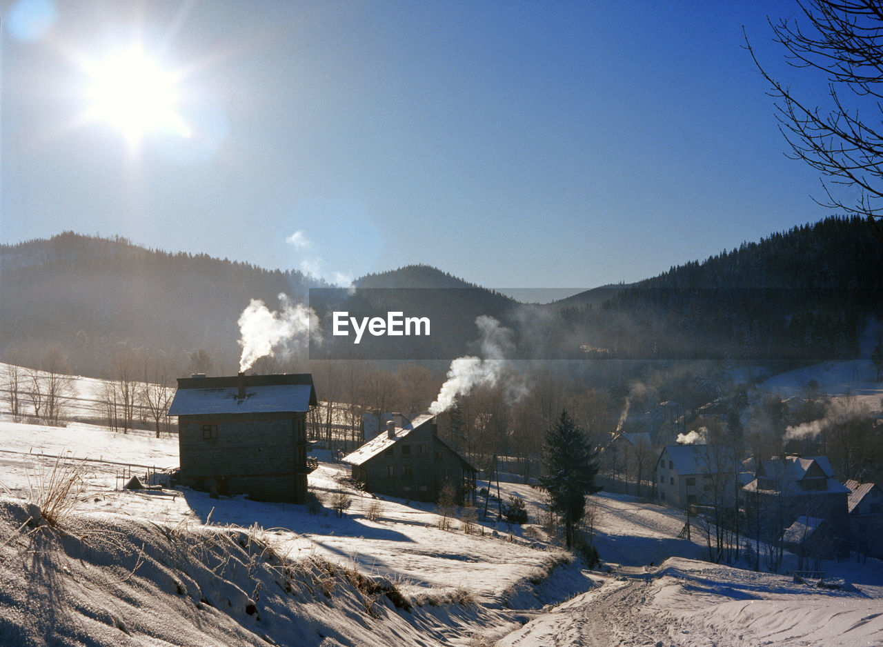 Scenic view of landscape against sky during winter