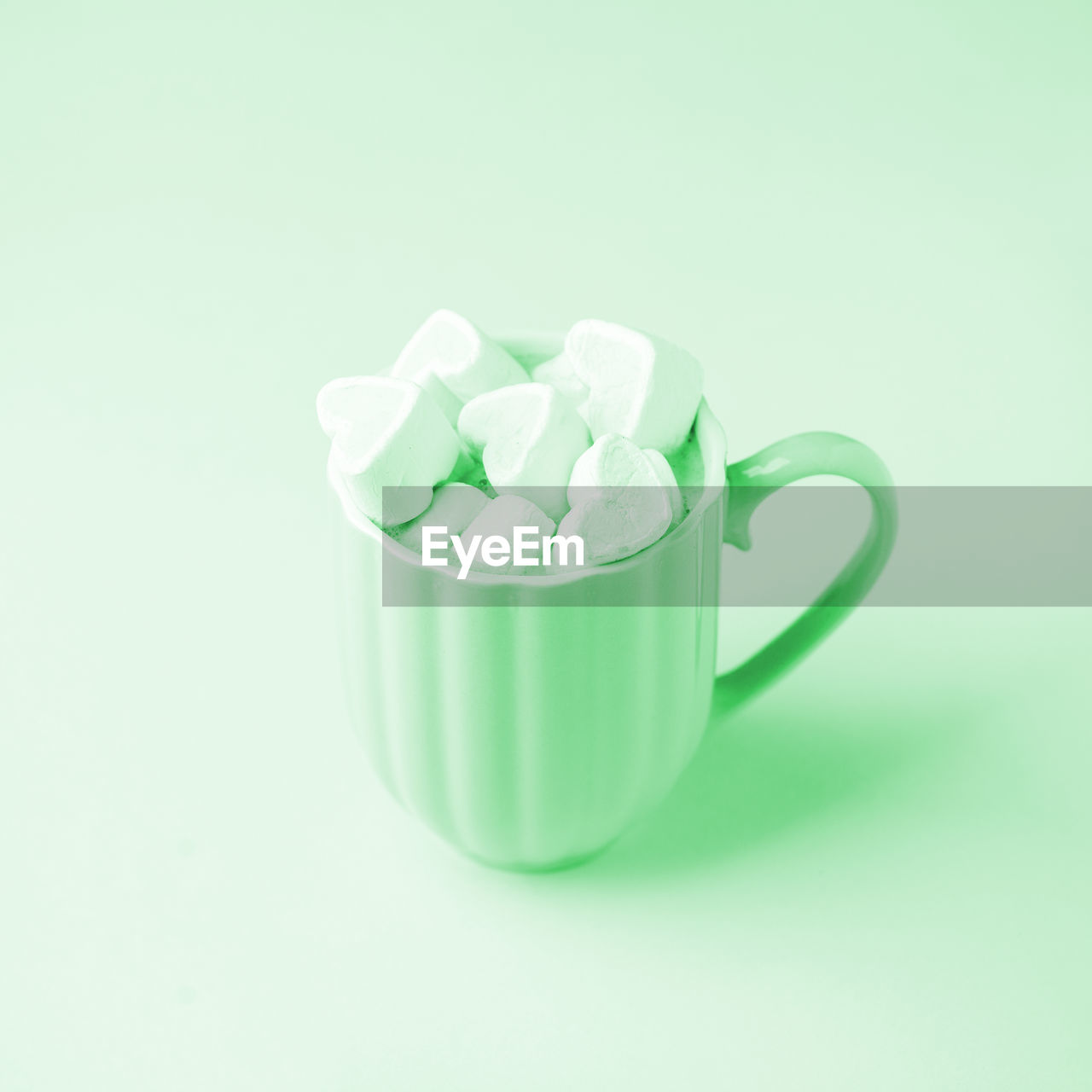 CLOSE-UP OF CUP OF COFFEE OVER WHITE BACKGROUND