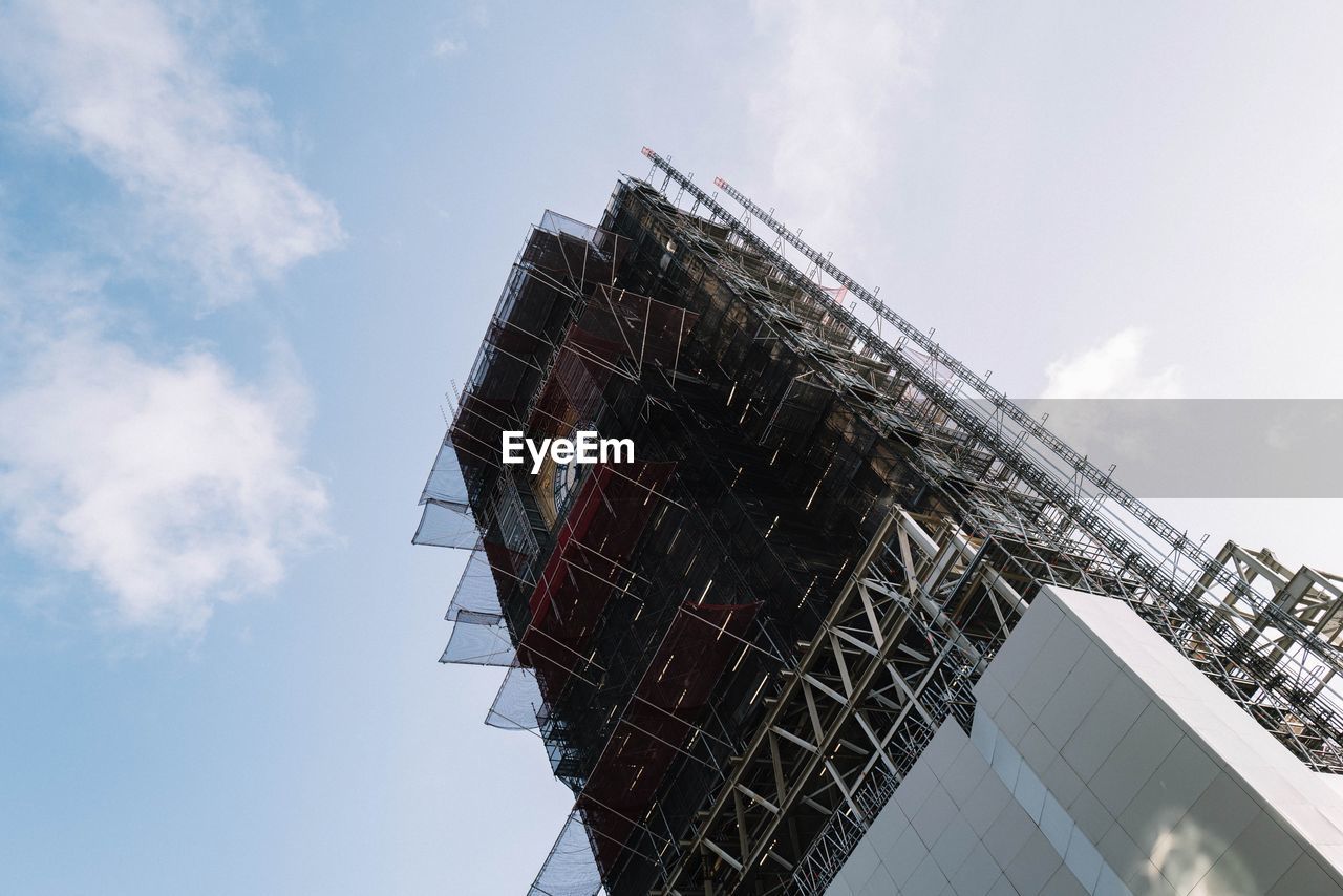 Low angle view of building under construction against sky