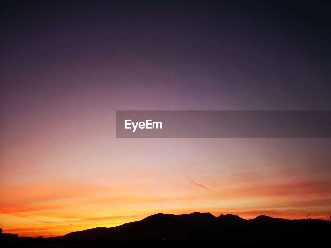 SCENIC VIEW OF DRAMATIC SKY OVER SILHOUETTE LANDSCAPE