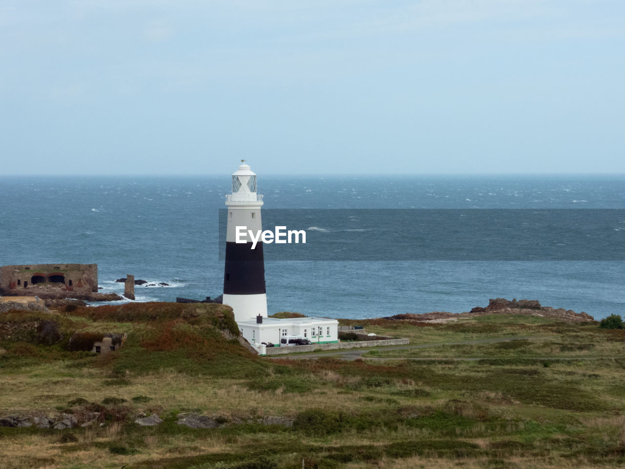 The mannez lighthouse  at quenard point on the northeastern side of the island of alderney,
