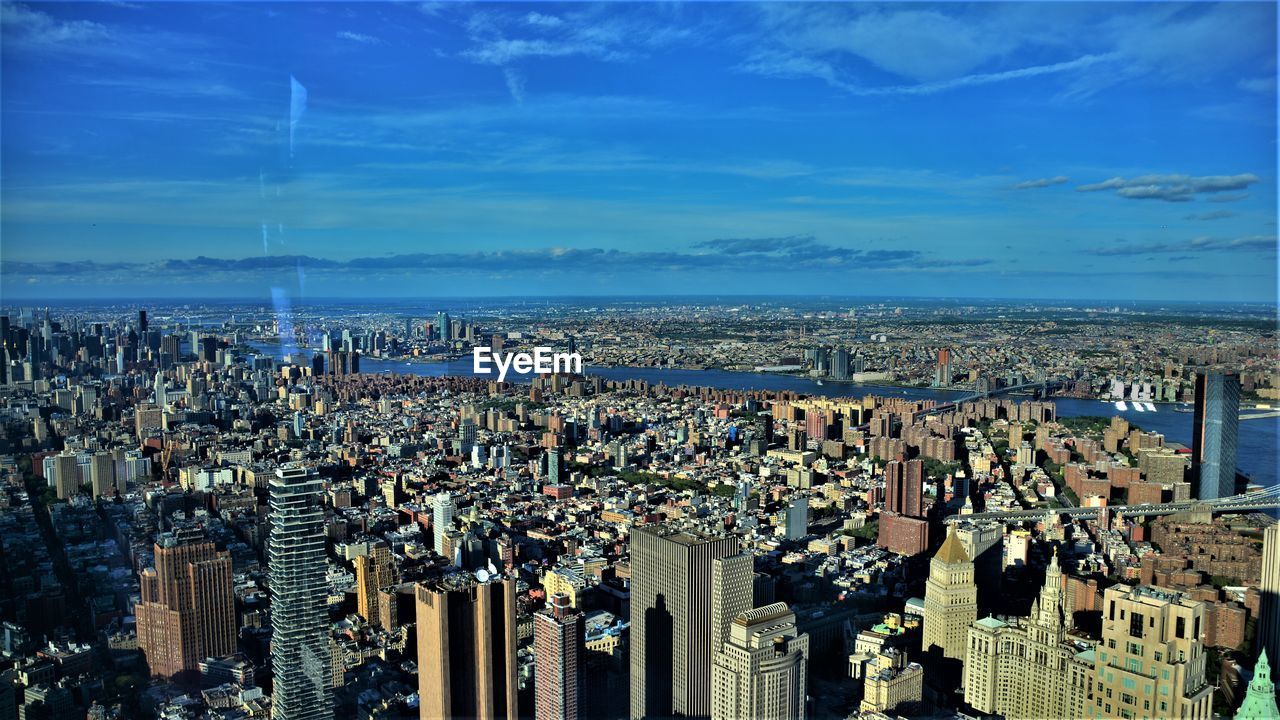 High angle view of buildings against blue sky