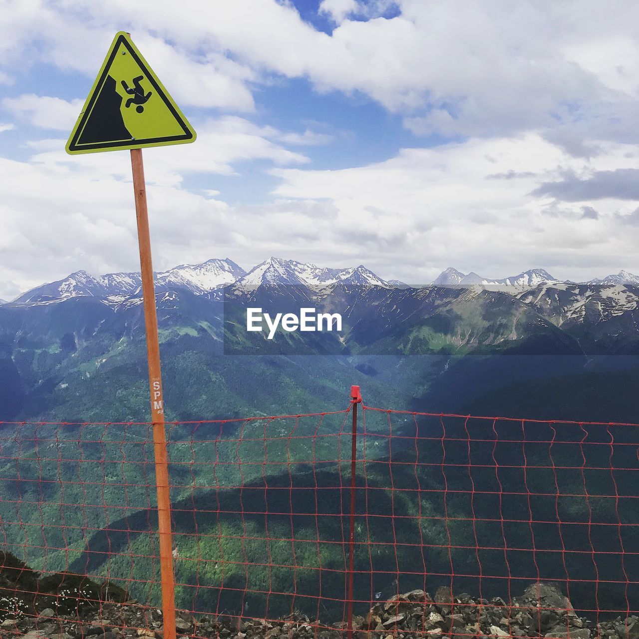 ROAD SIGN AGAINST MOUNTAIN