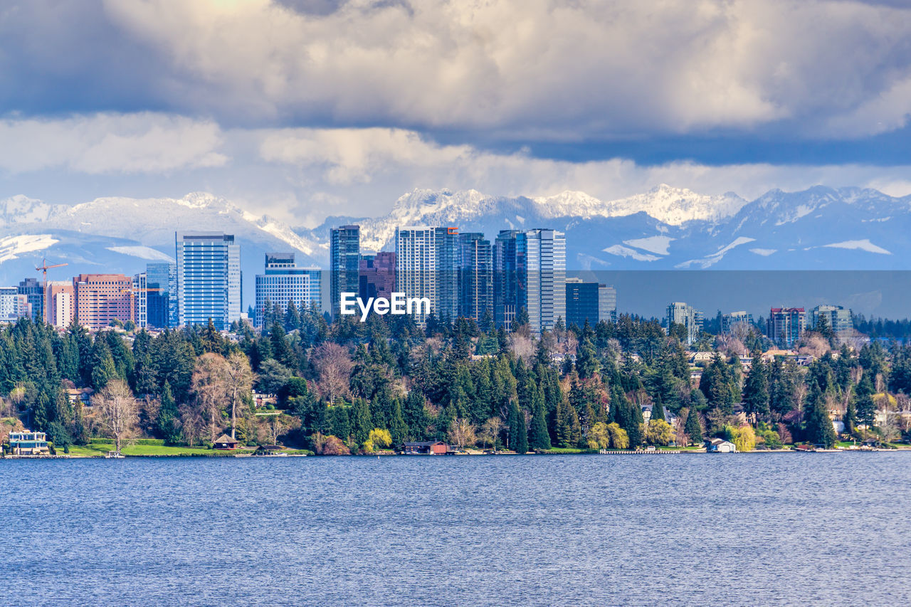 Modern buildings in bellevue, washington with the cascades range in the background.