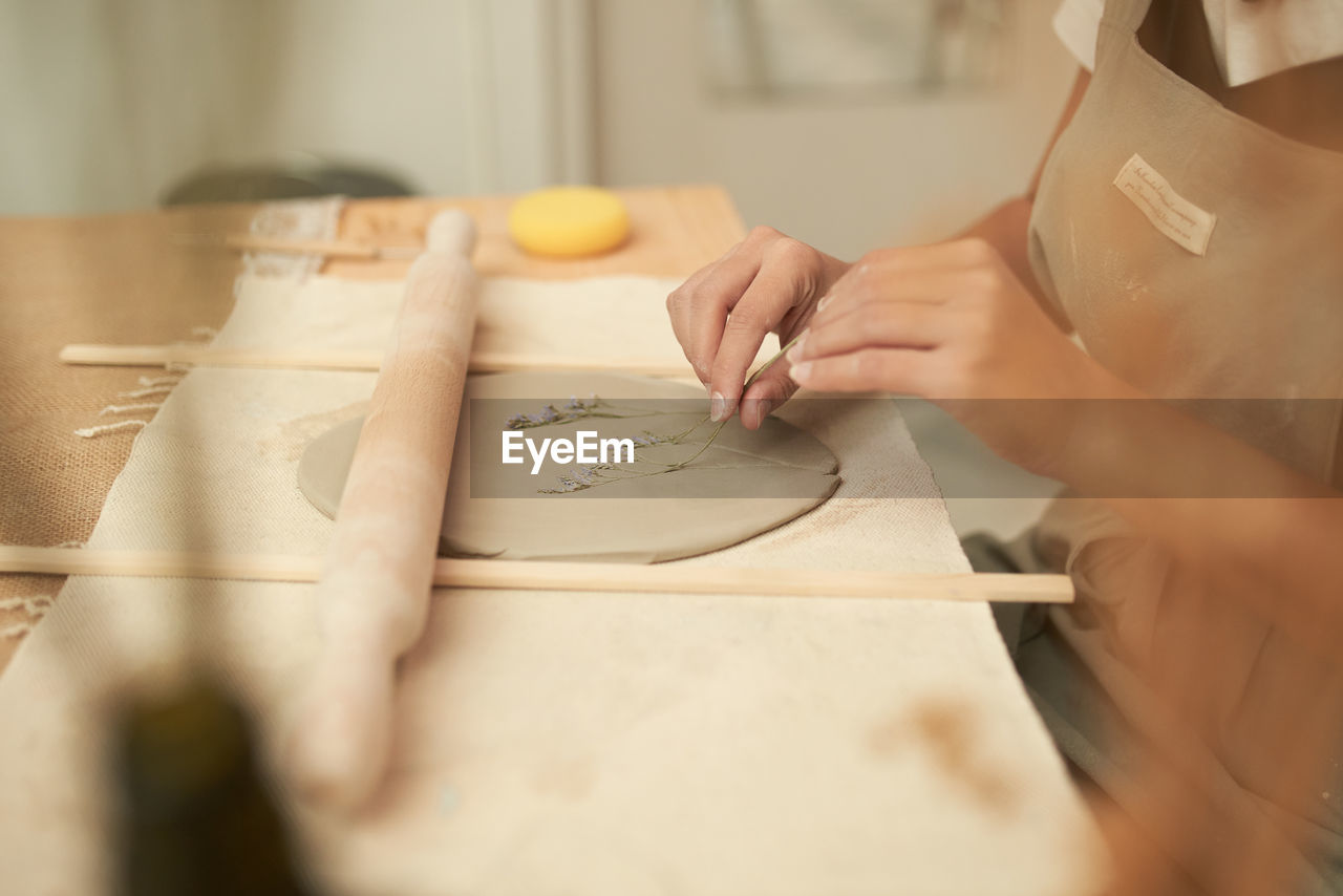 Midsection of woman holding paper with text on table