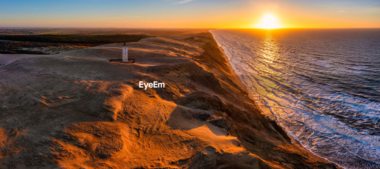 Rubjerg knude fyr lighthouse in sunset from drone