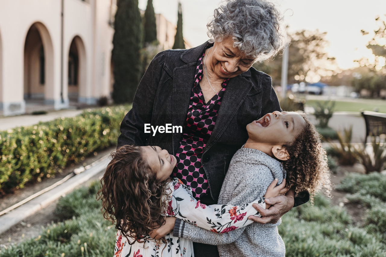 Close up lifestyle image of grandmother and grandchildren laughing