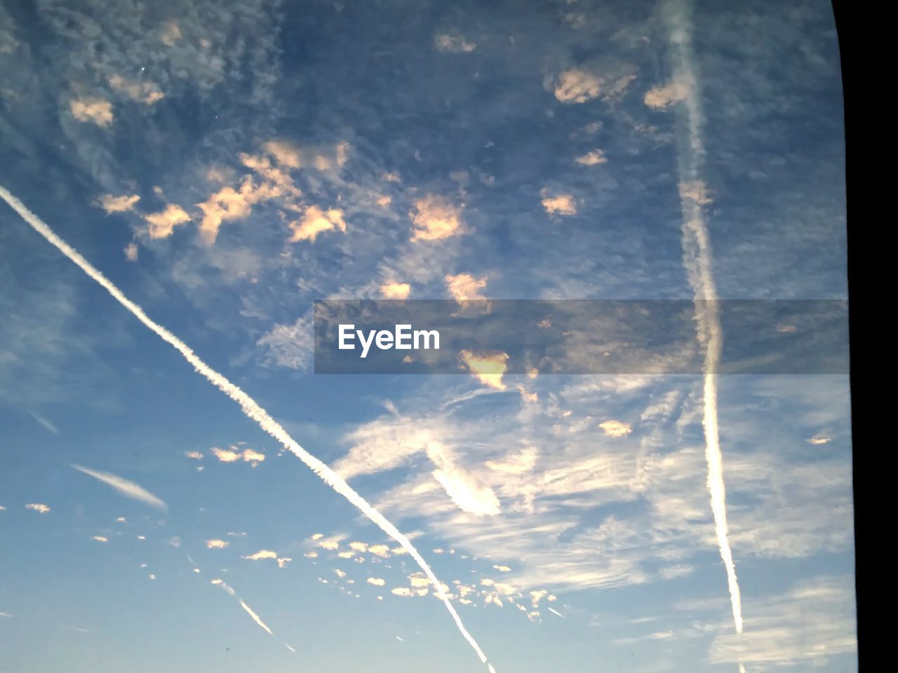 LOW ANGLE VIEW OF VAPOR TRAILS IN SKY