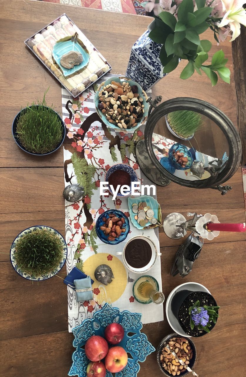 HIGH ANGLE VIEW OF BREAKFAST ON TABLE AGAINST PLANTS