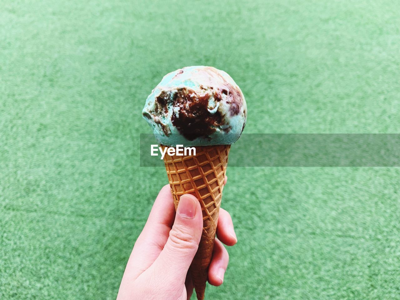 Cropped image of hand holding ice cream