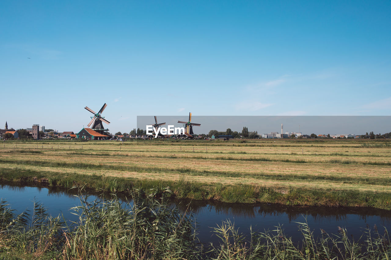 Traditional windmill on field against sky