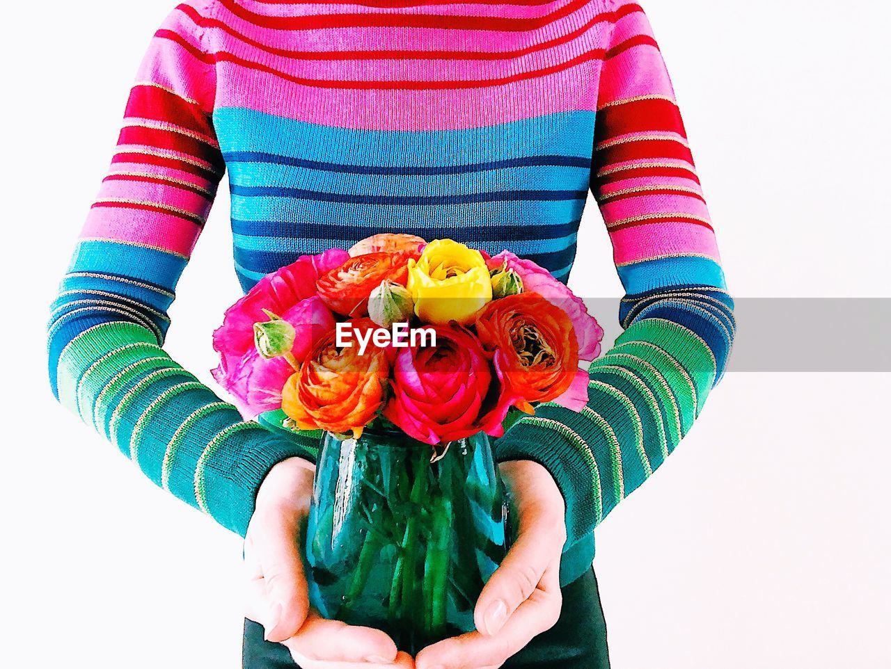 LOW SECTION OF WOMAN HOLDING BOUQUET OF ROSE