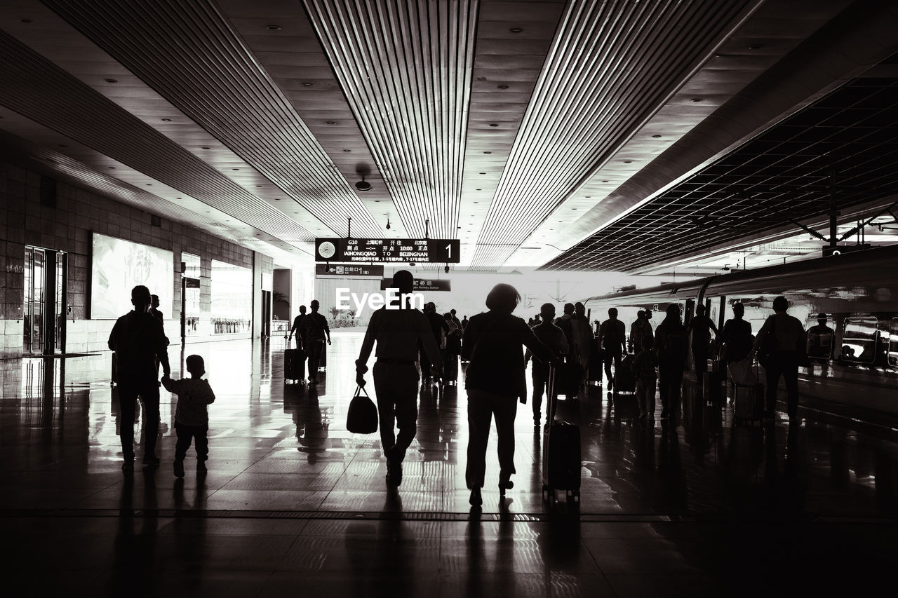 GROUP OF PEOPLE WALKING ON CORRIDOR