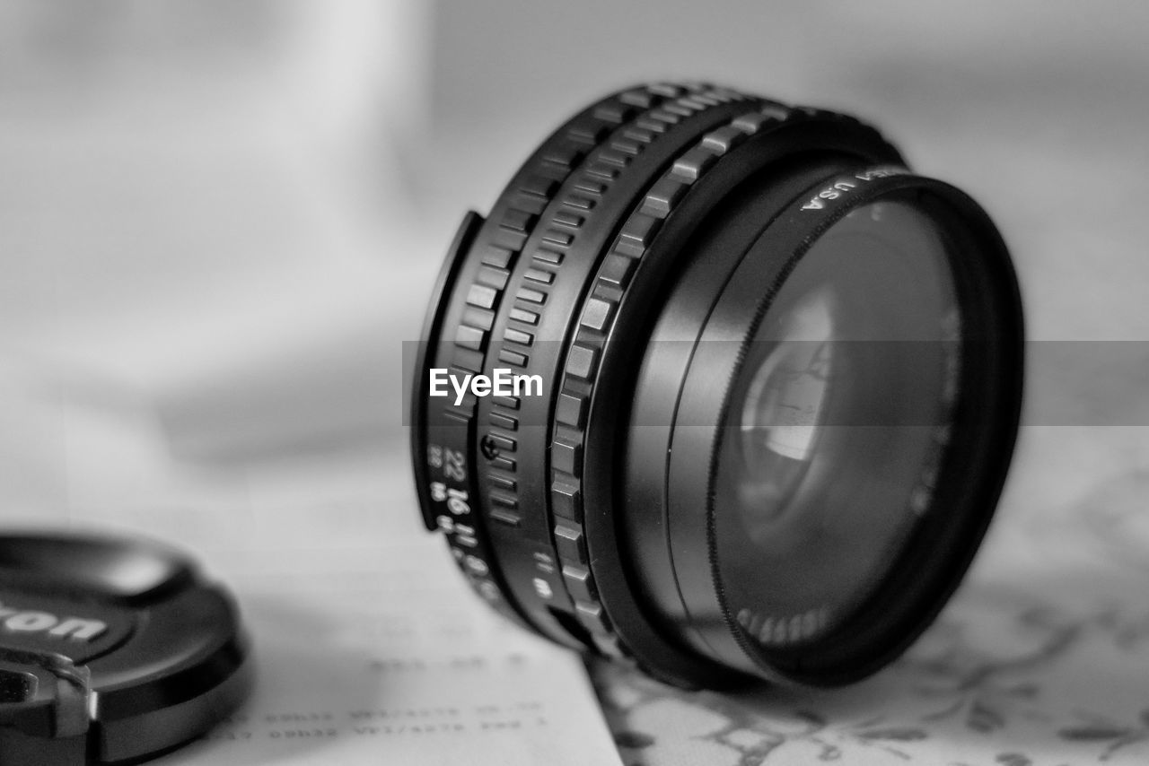 Close-up of camera lens on table