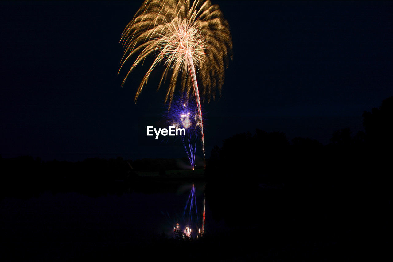 Gold and purple firework display at night