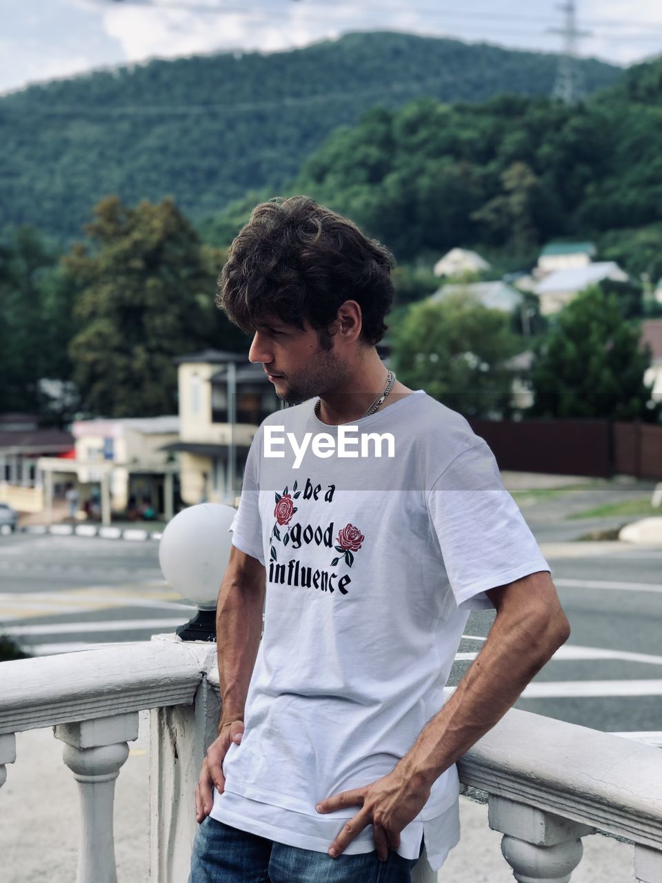 Young man standing against mountains