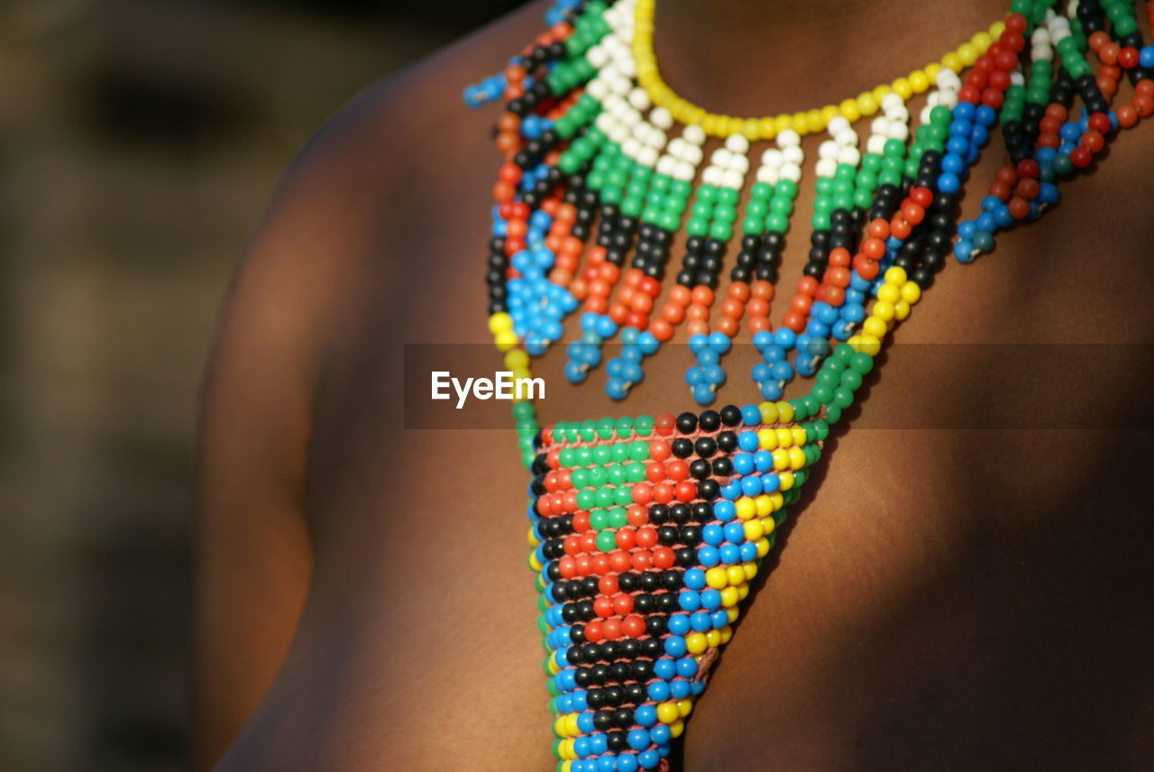 Beautiful traditional necklace on the lady in shadow,  zulu beadwork of south africa made by locals