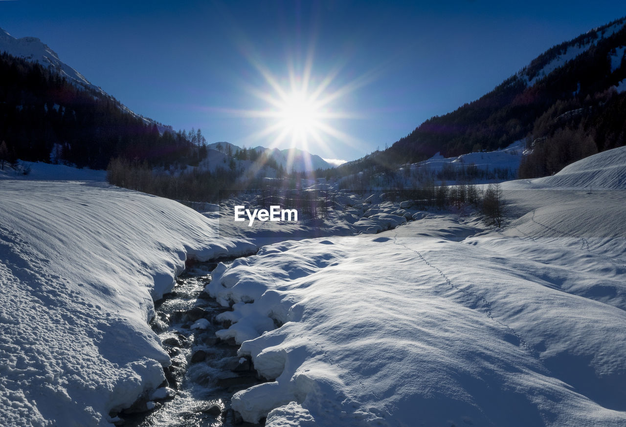 Scenic view of snow covered mountains against sky