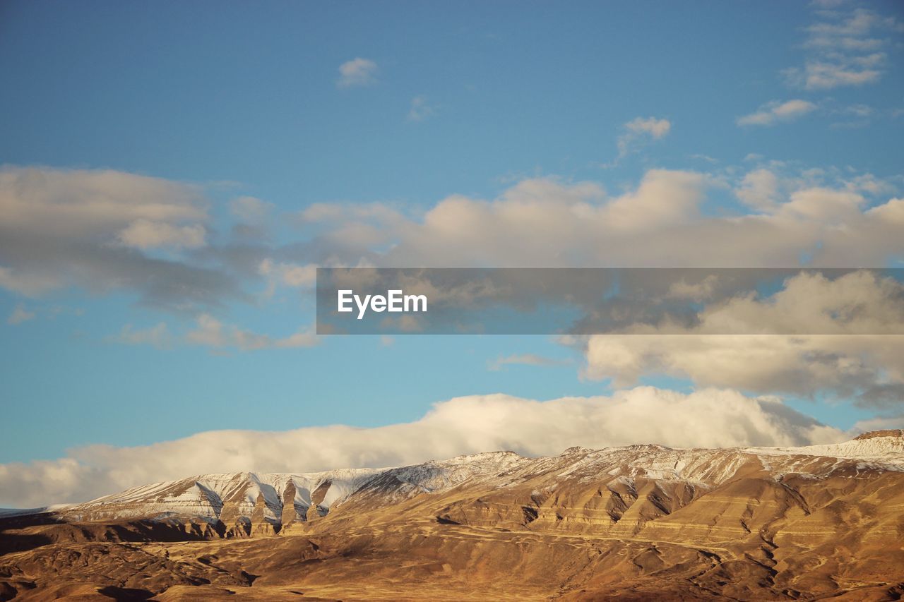 Scenic view of arid landscape against sky