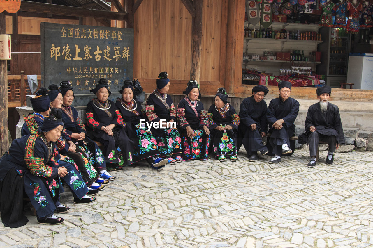 GROUP OF PEOPLE IN FRONT OF BUILDING