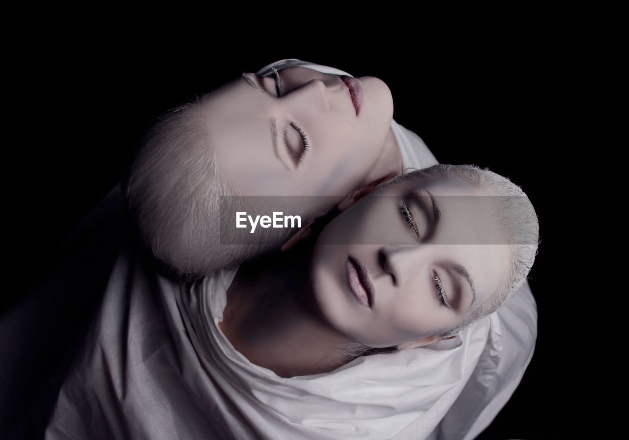 Directly above shot of women with make-up against black background