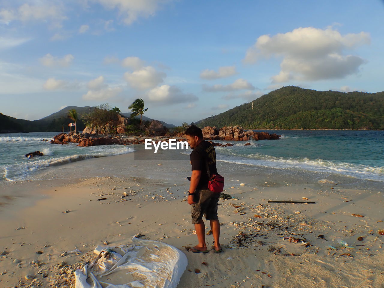 PEOPLE ON BEACH AGAINST SKY